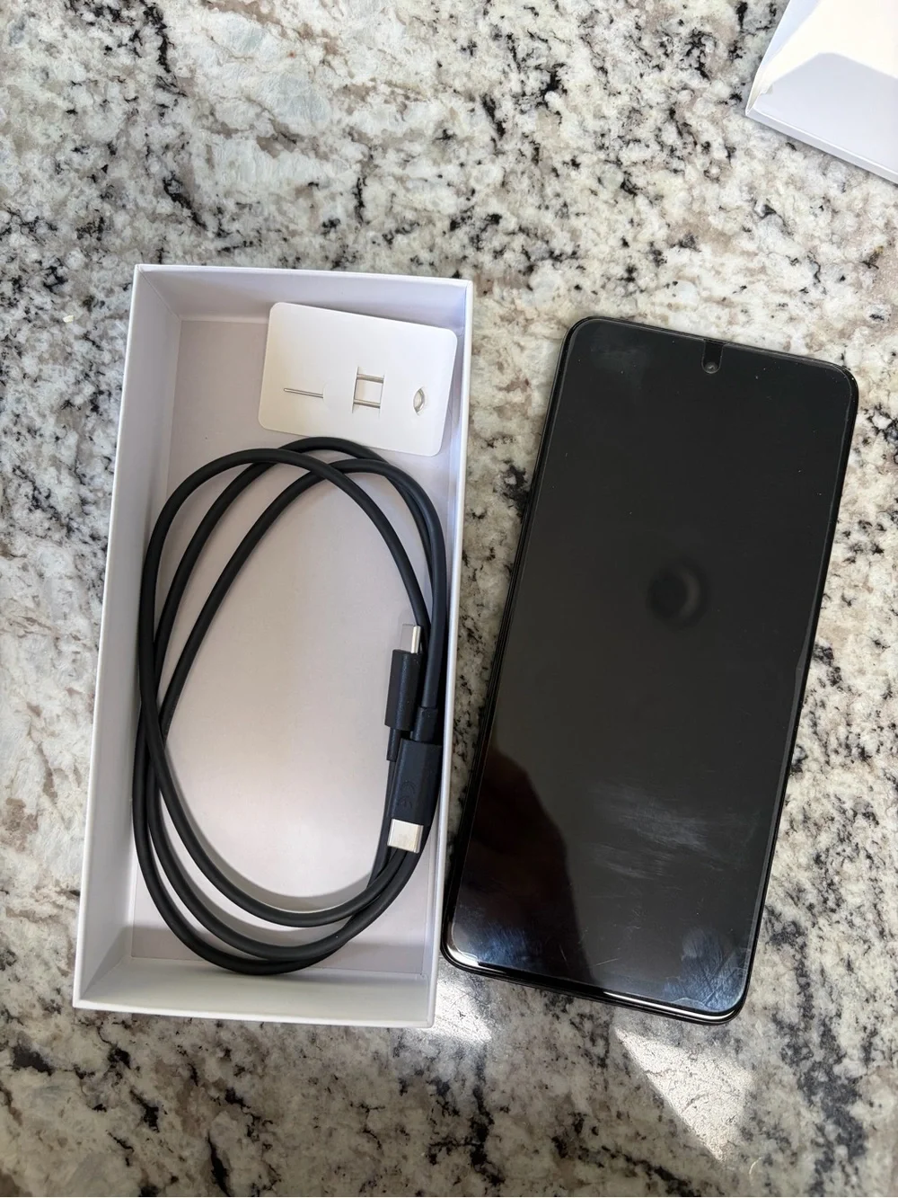 Motorola Moto G 2026 cell phone and charging cable